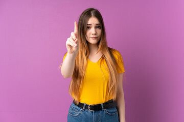 Fototapeta premium Young caucasian woman isolated on purple background counting one with serious expression