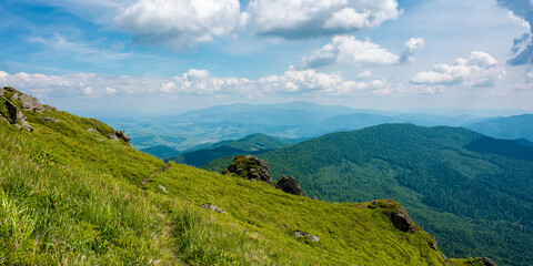 view from pikui mountain. huge stones on the grassy slopes. summer landscape of carpathian...