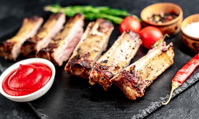 chopped pork ribs on the grill on a stone background