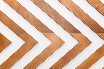 Beautiful background with the texture of thin wooden boards. The wall is made of diagonal slats. the bars are directed to the right