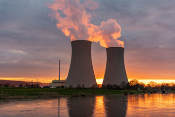 Nuclear power plant against sky by the river at sunset - 436537490