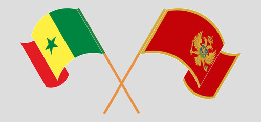 Crossed and waving flags of Senegal and Montenegro