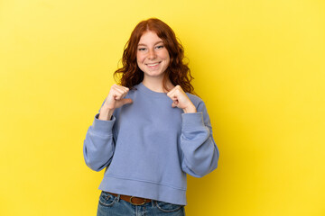 Teenager reddish woman isolated on yellow background with surprise facial expression