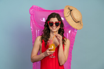 Relaxed, young girl in sunglasses resting on an air mattress. 
