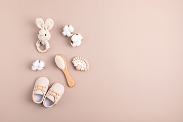 Baby shoes; rattle and teether on neutral background. Organic newborn gifts; branding; small...