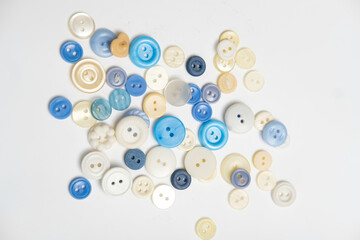 old plastic buttons in different colors on the background.