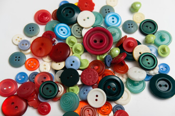 old plastic buttons in different colors on the background.