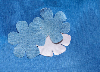 Flowers from old jeans. Decoration or recycling denim. Concept of things reuse and natural resources preserving.