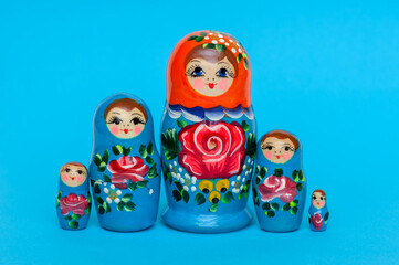 Matryoshka dolls on a blue background. Set of wooden toys Russian nesting dolls 