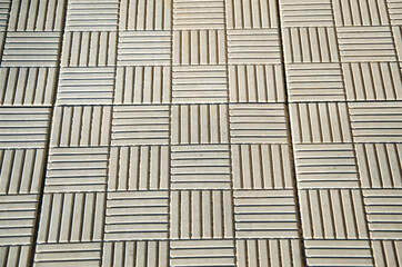 Brick texture footpath on walk with perspective going into the distance.