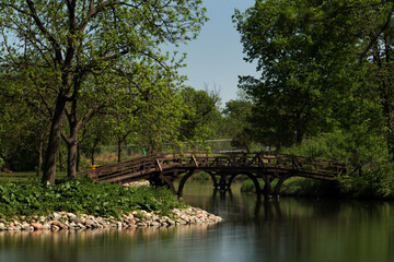 Wooden Pedestrian Bridge in summer at Lyman Lakes in Northfield, Minnesota