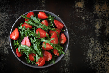 Healthy summer salad with strawberries and arugula. Summer diet.