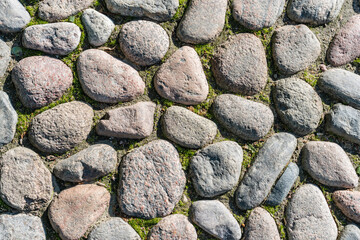 Paving stones background. Sidewalk and city roadway of the old town. Top view.