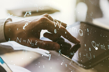 Double exposure of creative scientific formula concept with finger clicks on a digital tablet on...