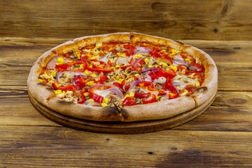 Delicious fresh pizza on a wooden table