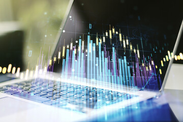 Abstract creative financial graph on modern laptop background, forex and investment concept. Multiexposure