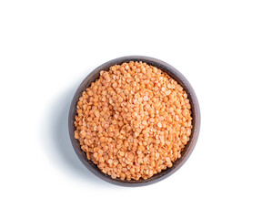 Dried red lentils in a wooden bowl isolated on white