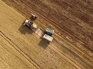 Harvesting machine working in the field. Top view from the drone Combine harvester agricultural...
