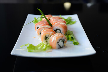 Sushi rolls on white dish. Japanese food.