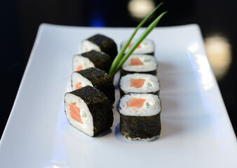 Sushi rolls on white dish. Japanese food.