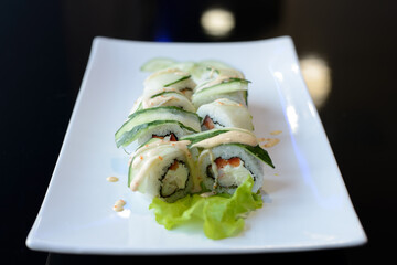 Sushi rolls on white dish. Japanese food.