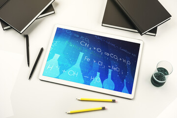 Creative chemistry illustration on modern digital tablet display, science and research concept. Top view. 3D Rendering