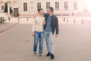 Fototapeta na wymiar Cute gay couple in the city, tender gentle kissing, smiling