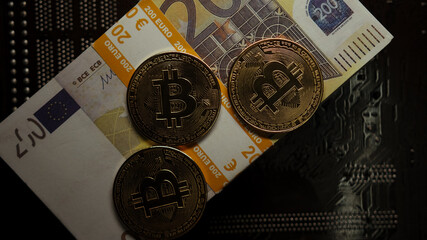 Bitcoin close-up on 200 euro banknotes, white light top view, finance and crypto concept