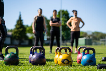 Kettlebell weightlifting. Group training after a lockdown outside the city. Get in shape - 436556064