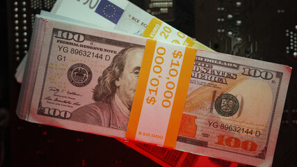 Dollar and euro banknotes on the motherboard, finance concept