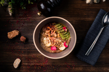 Raw linen cereal with fruits, nuts in bowl. Super food for healthy nutritious breakfast