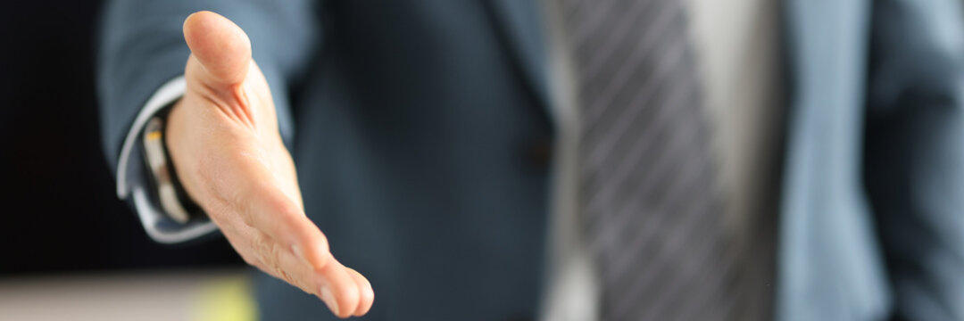 Man In Business Suit Giving His Hand For Handshake Closeup