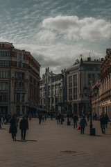 Obraz premium Center of Moscow with historic vintage buildings and walking people. Toned vertical photo