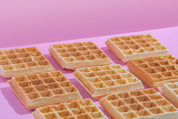 Waffles pattern on a pink background.