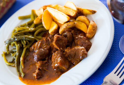 Delicious Veal Stew Served With Pickled Wild Garlic With Fried Potatoes..