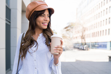 Young woman holding a cup of coffee.