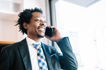 Businessman talking on phone at office.