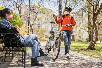 Courier man wearing protective mask going to the client