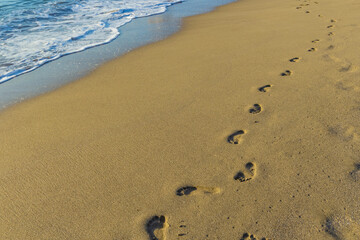 Human footprints on the sea sand. Vacation in the coast of Spanish Canary islands. Santa Cruz de Tenerife