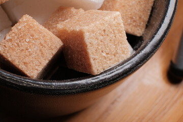 macro brown sugar cube in sugar bowl