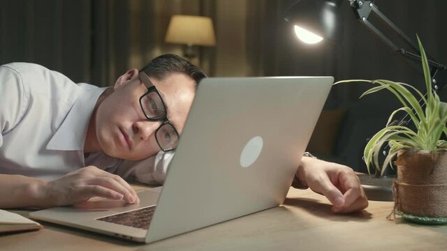 Asia Man Bored While Working From Home At Living Room At Night
