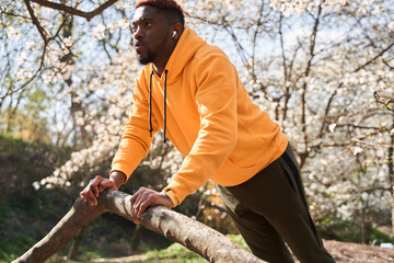 Sportsman wearing running outfit doing push ups before physical workout