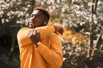 Man stretching after exercise outdoors at spring park