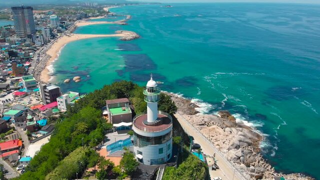 Lighthouse at day time of east coast sea of Korea. Clear sea surface is emerald color. Weather is good. Beautiful nature and landmark aerial drone footage took with 4K 30fps.