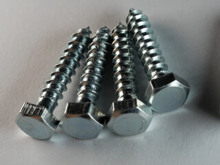 Closeup shot of lag screws on a white surface