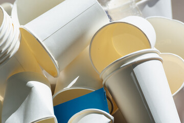 Disposable white cups in the trash.