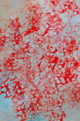 abstract creative background: red blurred stains of colored primer when toning the canvas, temporary object.