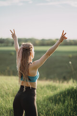 Sporty fit woman raising arms express positivity