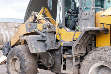 Large bulldozer rear and left. Dirty yellow bulldozer close-up with open cab.