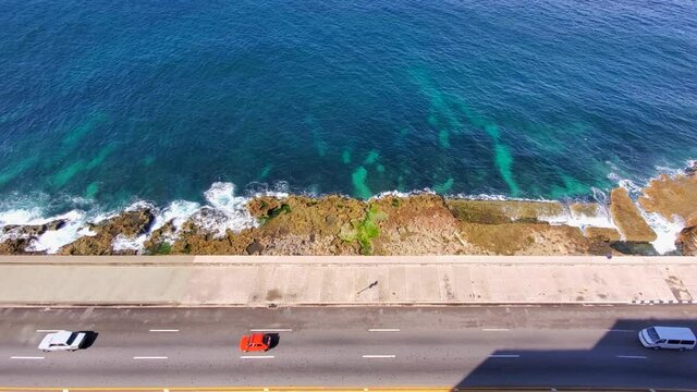 A view from above at traffic on EL Malecon, Avenida de Maceo, a broad landmark esplanade that stretches for 8 km along the coast in Havana past major city tourist attractions.